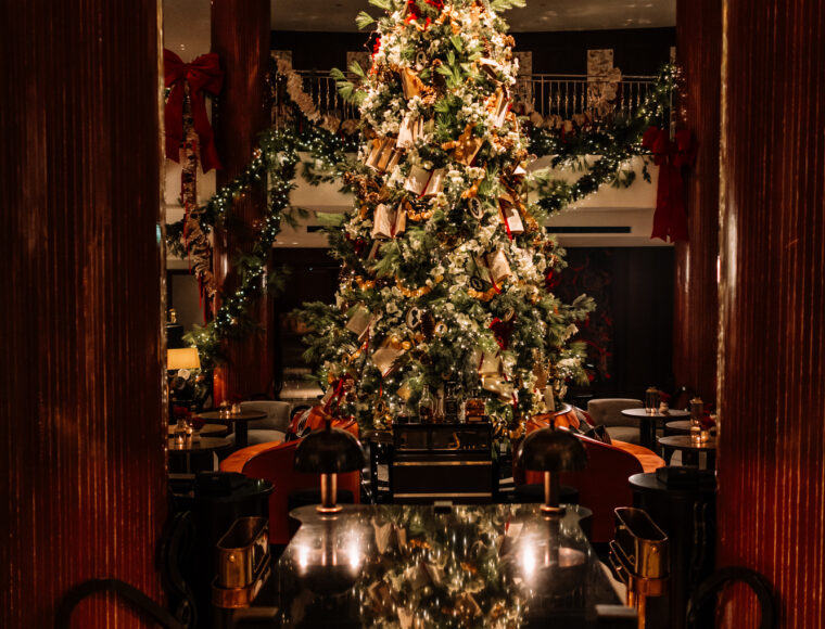 Christmas tree display in the Lobby Bar at One Aldwych Hotel, Covent Garden, London, decorated with festive lights and seasonal ornaments