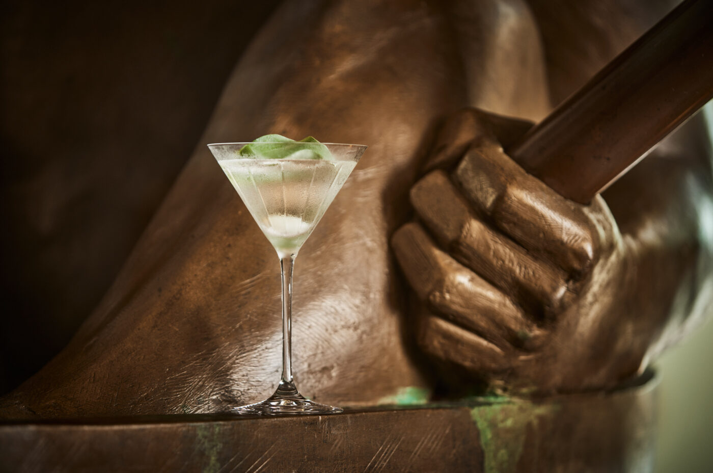Chilled martini cocktail garnished with an onion and oyster leaf in a crystal martini glass at One Aldwych, Covent Garden.